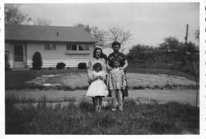 Doreen and her family in front of my childhood home.